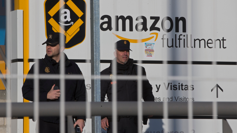 Police officers guard the Madrid-region Amazon warehouse in question during a prior strike in March 2018.